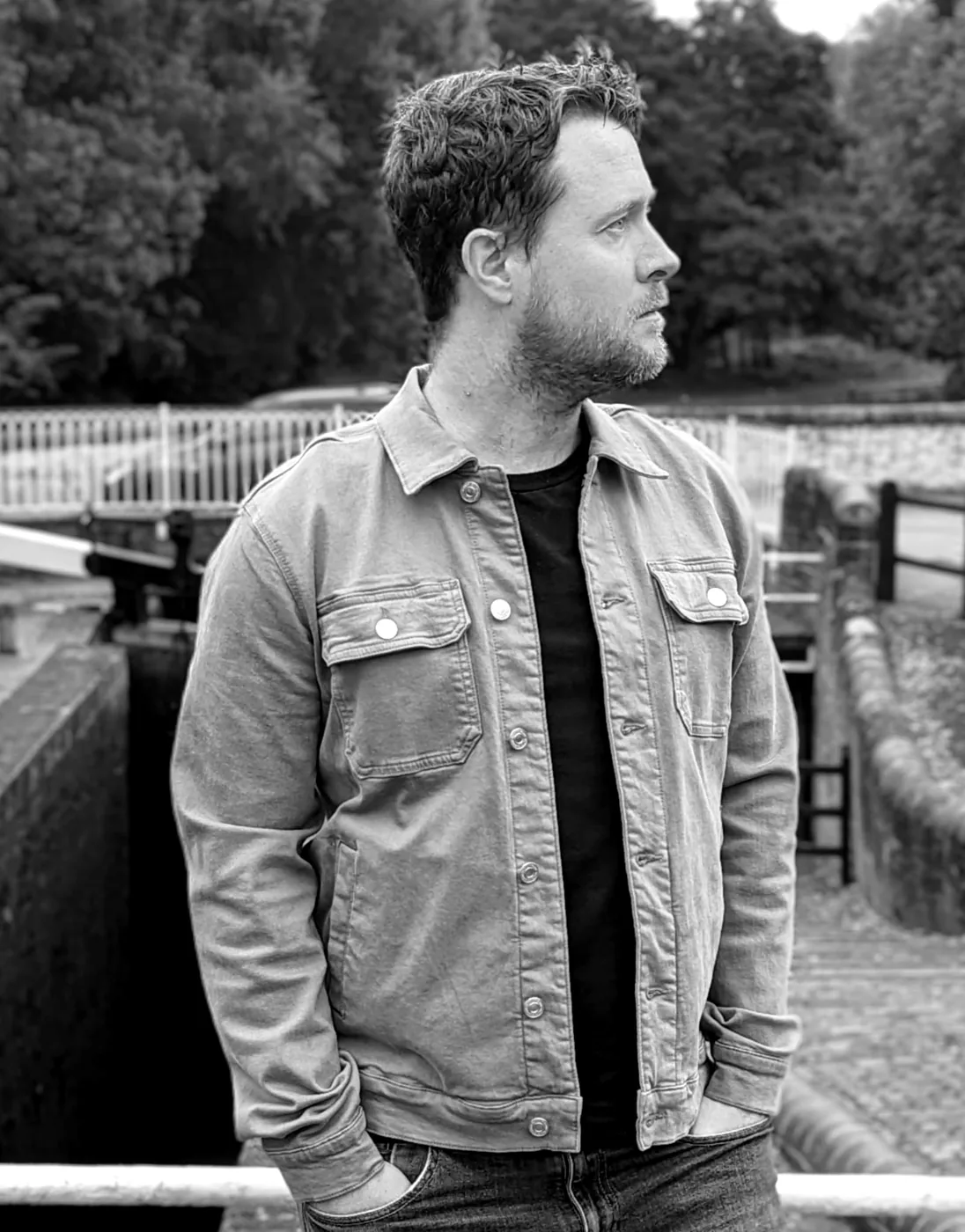 James by a canal, in black and white