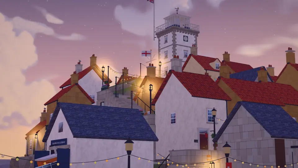 Cottages with red roofs below the white Coastwatch Tower at sunset. The street lamps light up one by one.