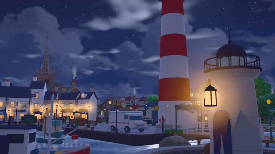 Dusk by the little harbour lighthouse. A lantern lights up next to the door, with the lit town behind it.